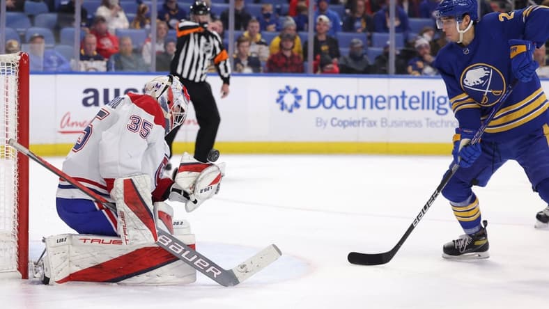 Nov 26, 2021; Buffalo, New York, USA;  Buffalo Sabres center Dylan Cozens (24) waits for a rebound as Montreal Canadiens goaltender Sam Montembeault (35) tries to make a glove save during the second period at KeyBank Center. Mandatory Credit: Timothy T. Ludwig-USA TODAY Sports