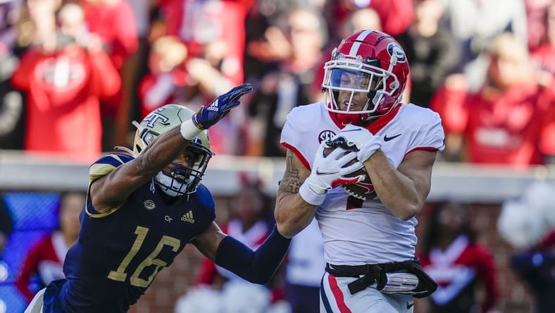 Nov 27, 2021; Atlanta, Georgia, USA; Georgia Bulldogs wide receiver Jermaine Burton (7) catches a touchdown pass behind Georgia Tech Yellow Jackets defensive back Myles Sims (16) during the first quarter at Bobby Dodd Stadium. Mandatory Credit: Dale Zanine-USA TODAY Sports