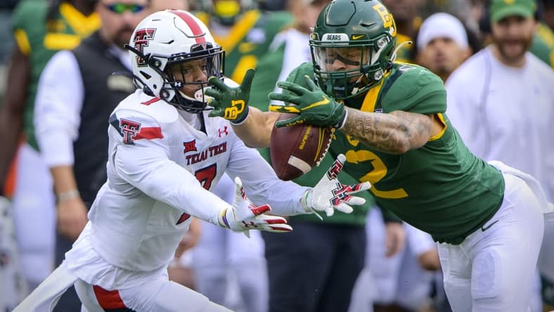 Nov 27, 2021; Waco, Texas, USA; Texas Tech Red Raiders quarterback Donovan Smith (7) and Baylor Bears linebacker Terrel Bernard (2) dive for the ball on a muffed punt by Smith during the first half at McLane Stadium. Mandatory Credit: Jerome Miron-USA TODAY Sports