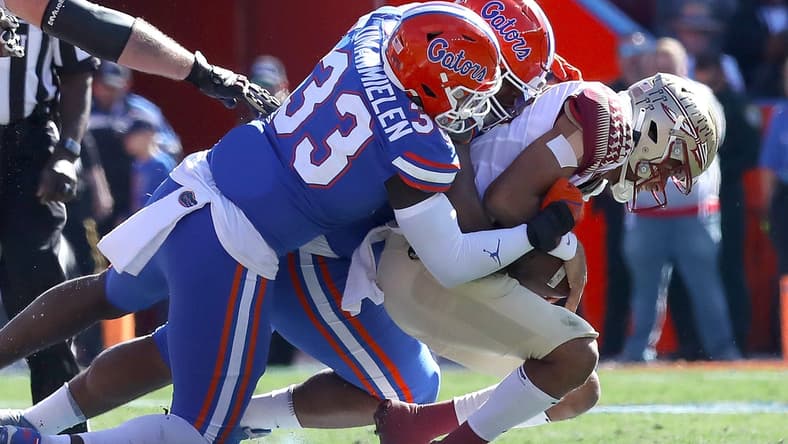 Florida State Seminoles quarterback Jordan Travis (13) is tackles by Florida Gators defenders during a game at Ben Hill Griffin Stadium in Gainesville Fla., Nov. 27, 2021.
Flagi 112721 Ufvfsu Fb 06