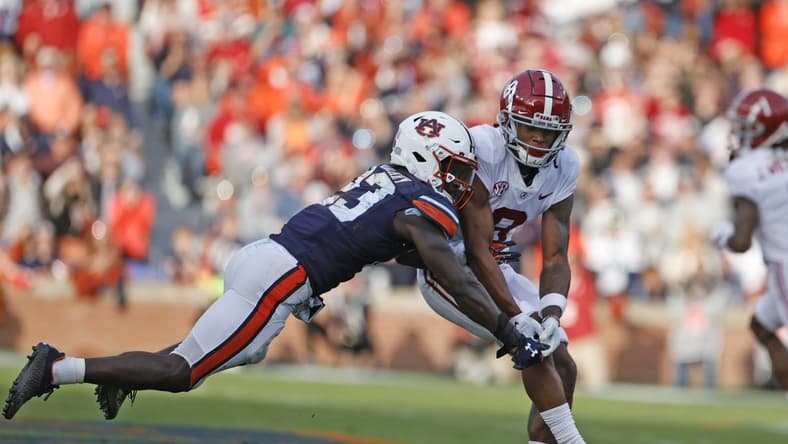 Nov 27, 2021; Auburn, Alabama, USA; Auburn Tigers cornerback Roger McCreary (23) breaks up a pass intended for Alabama Crimson Tide wide receiver John Metchie III (8) during the second quarter at Jordan-Hare Stadium. Mandatory Credit: John Reed-USA TODAY Sports