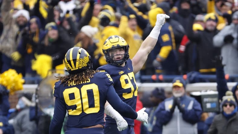 Nov 27, 2021; Ann Arbor, Michigan, USA; Michigan Wolverines defensive end Aidan Hutchinson (97) celebrates his sad of Ohio State Buckeyes quarterback C.J. Stroud (not pictured) with defensive end Mike Morris (90) in the second half in the second half at Michigan Stadium. Mandatory Credit: Rick Osentoski-USA TODAY Sports