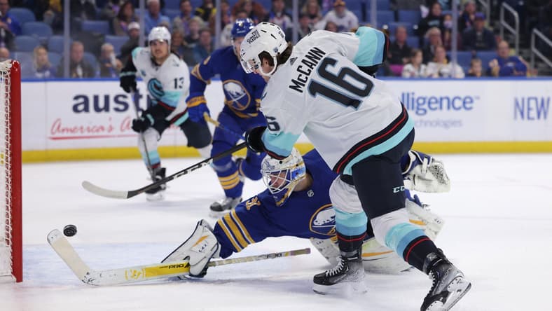 Nov 29, 2021; Buffalo, New York, USA; Buffalo Sabres goaltender Dustin Tokarski (31) dives to try and make a save as Seattle Kraken center Jared McCann (16) takes a shot and scores during the first period at KeyBank Center. Mandatory Credit: Timothy T. Ludwig-USA TODAY Sports