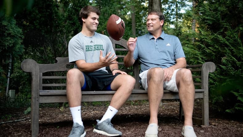 Christ School senior quarterback Navy Shuler and his dad, former NFL quarterback Heath Shuler, in the backyard of their home on July 2, 2019. 

Tab Shuler 02