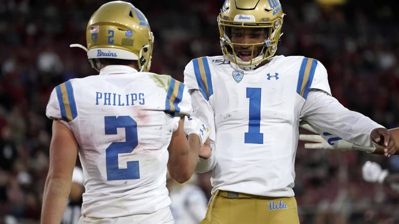 Oct 17, 2019; Stanford, CA, USA; UCLA Bruins quarterback Dorian Thompson-Robinson (1) and wide receiver Kyle Philips (2) celebrate after a touchdown in the first half against the Stanford Cardinal at Stanford Stadium. Mandatory Credit: Kirby Lee-USA TODAY Sports