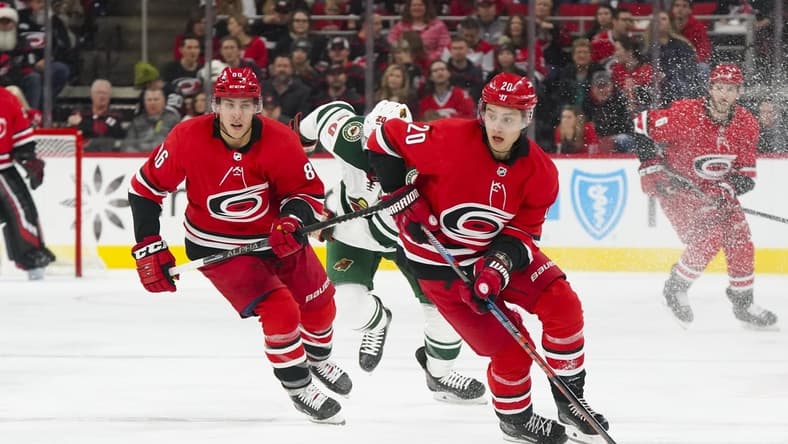Dec 7, 2019; Raleigh, NC, USA;  Carolina Hurricanes center Sebastian Aho (20) skates up the ice with the puck with left wing Teuvo Teravainen (86) against the Minnesota Wild at PNC Arena. The Carolina Hurricanes defeated the Minnesota Wild 6-2. Mandatory Credit: James Guillory-USA TODAY Sports