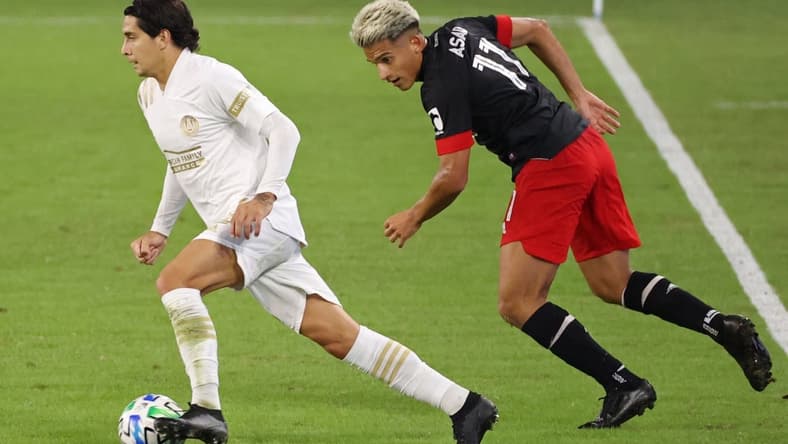 Oct 3, 2020; Washington, DC, Washington, DC, USA; Atlanta United FC defender Franco Escobar (2) dribbles the ball past D.C. United midfielder Yamil Asad (11) in the first half at Audi Field. Mandatory Credit: Geoff Burke-USA TODAY Sports