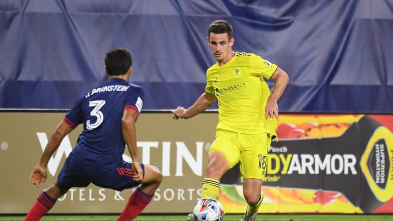 Jul 17, 2021; Nashville, TN, USA; Nashville SC defender Dylan Nealis (18) passes the ball while defended by Chicago Fire defender Jonathan Bornstein (3) during the second half at Nissan Stadium. Mandatory Credit: Christopher Hanewinckel-USA TODAY Sports