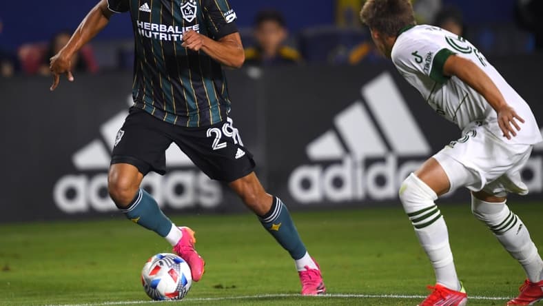 Jul 30, 2021; Carson, California, USA; Portland Timbers midfielder Blake Bodily (98) defends Los Angeles Galaxy forward Ethan Zubak (29) as he takes the ball to the goal in the second half of the game at StubHub Center. Mandatory Credit: Jayne Kamin-Oncea-USA TODAY Sports
