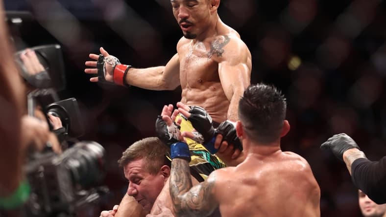 Aug 7, 2021; Houston, Texas, USA; Jose Aldo (red gloves) reacts to fight against Pedro Munhoz (blue gloves) during UFC 265 at Toyota Center. Mandatory Credit: Troy Taormina-USA TODAY Sports