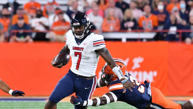 Sep 24, 2021; Syracuse, New York, USA; Liberty Flames quarterback Malik Willis (7) escapes a tackle by Syracuse Orange linebacker Mikel Jones (3) in the first quarter at the Carrier Dome. Mandatory Credit: Mark Konezny-USA TODAY Sports