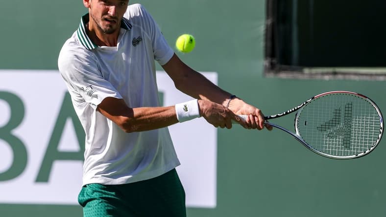 Daniil Medvedev of Russia returns to Grigor Dimitrov of Bulgaria during their round four match of the BNP Paribas Open, Wednesday, Oct. 13, 2021, in Indian Wells, Calif.