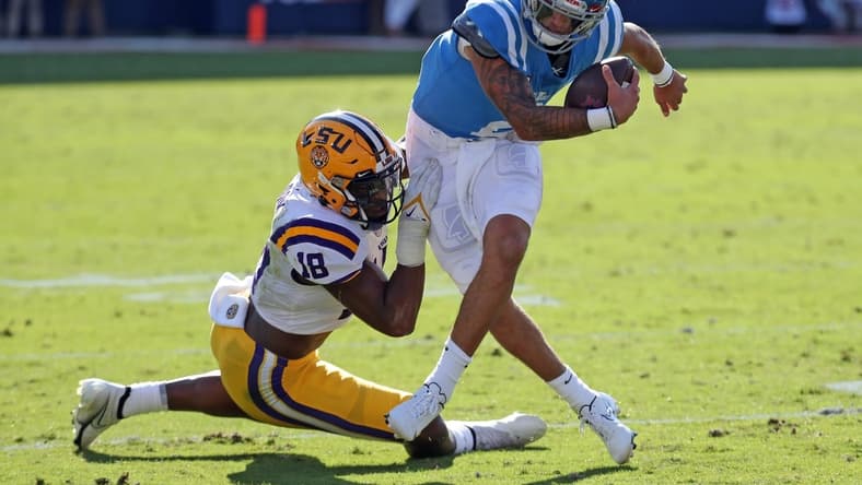 Oct 23, 2021; Oxford, Mississippi, USA; Mississippi Rebels quarterback Matt Corral (2) is sacked for a loss by LSU Tigers linebacker Damone Clark (18) during the first half at Vaught-Hemingway Stadium. Mandatory Credit: Petre Thomas-USA TODAY Sports