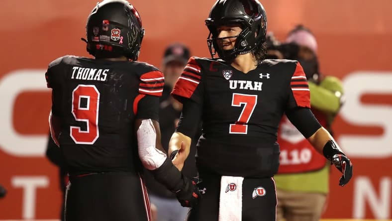 Oct 30, 2021; Salt Lake City, Utah, USA;  Utah Utes running back Tavion Thomas (9) celebrates his touchdown with quarterback Cameron Rising (7) during the fourth quarter against the UCLA Bruins at Rice-Eccles Stadium. Mandatory Credit: Rob Gray-USA TODAY Sports