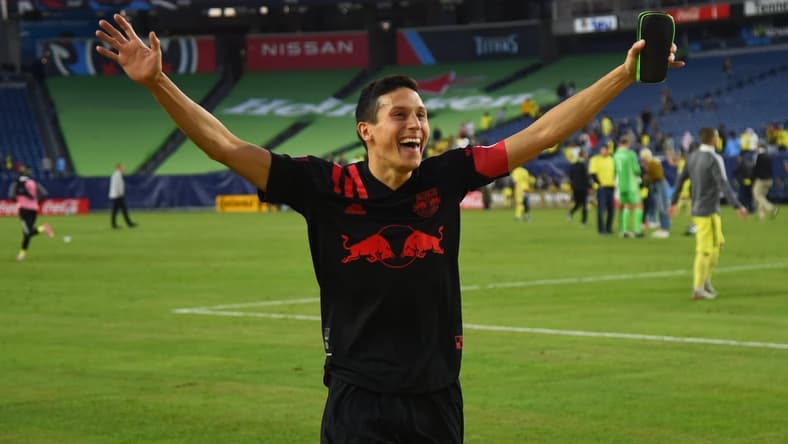 Nov 7, 2021; Nashville, Tennessee, USA; New York Red Bulls midfielder Sean Davis (27) celebrates after a draw against the Nashville SC at Nissan Stadium. Mandatory Credit: Christopher Hanewinckel-USA TODAY Sports