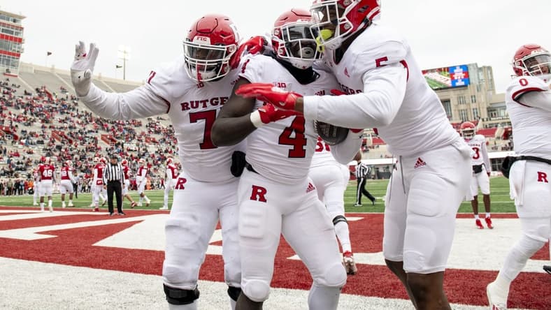 Nov 13, 2021; Bloomington, Indiana, USA; The Rutgers Scarlet Knights celebrate a touchdown by running back Aaron Young (4) during the second half against the Indiana Hoosiers at Memorial Stadium. The Scarlet Knights won 38-3.  Mandatory Credit: Marc Lebryk-USA TODAY Sports