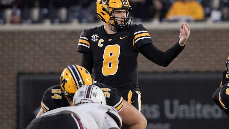Nov 13, 2021; Columbia, Missouri, USA; Missouri Tigers quarterback Connor Bazelak (8) gestures at the line of scrimmage against the South Carolina Gamecocks during the second half at Faurot Field at Memorial Stadium. Mandatory Credit: Denny Medley-USA TODAY Sports