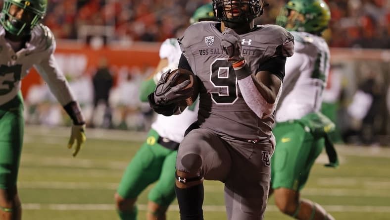 Nov 20, 2021; Salt Lake City, Utah, USA; Utah Utes running back Tavion Thomas (9) runs for a touchdown in the third quarter against the Oregon Ducks at Rice-Eccles Stadium. Mandatory Credit: Jeffrey Swinger-USA TODAY Sports