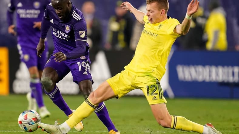 Nashville SC defender Alistair Johnston (12) defends against Orlando City forward Benji Michel (19) during the second half of an MLS playoff soccer match at Nissan Stadium in Nashville, Tenn., Tuesday, Nov. 23, 2021.

Nsc Oc Mls 112321 Aan 023