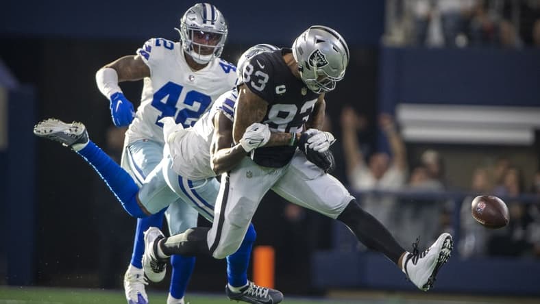 Nov 25, 2021; Arlington, Texas, USA; Las Vegas Raiders tight end Darren Waller (83) drops the ball as he is tackled by Dallas Cowboys safety Jayron Kearse (27) during the first quarter at AT&T Stadium. Mandatory Credit: Jerome Miron-USA TODAY Sports