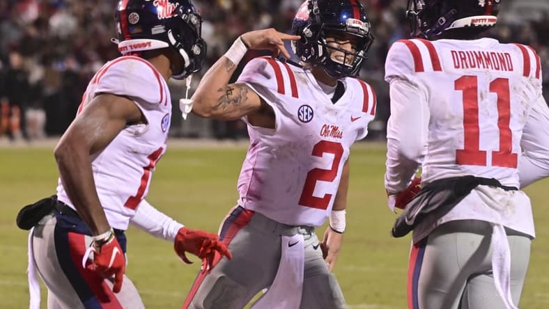 Nov 25, 2021; Starkville, Mississippi, USA; Mississippi Rebels quarterback Matt Corral (2) reacts after scoring a touchdown against the Mississippi State Bulldogs during the fourth quarter at Davis Wade Stadium at Scott Field. Mandatory Credit: Matt Bush-USA TODAY Sports