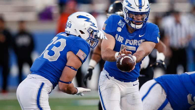 Nov 26, 2021; Colorado Springs, Colorado, USA; Air Force Falcons quarterback Jensen Jones (5) hands the ball off to outside linebacker Jet Harris (33) in the fourth quarter against the UNLV Rebels at Falcon Stadium. Mandatory Credit: Isaiah J. Downing-USA TODAY Sports