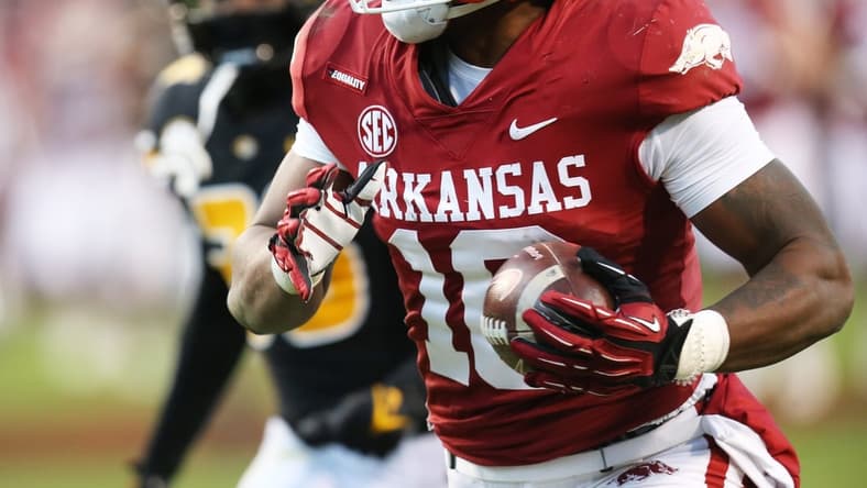 Nov 26, 2021; Fayetteville, Arkansas, USA; Arkansas Razorbacks wide receiver Treylon Burks (16) catches a pass and runs it in for a touchdown in the third quarter against the Missouri Tigers at Donald W. Reynolds Razorbacks Stadium. Mandatory Credit: Nelson Chenault-USA TODAY Sports