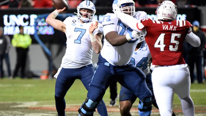 Nov 26, 2021; Raleigh, North Carolina, USA;  North Carolina Tar Heels quarterback Sam Howell (7) throws a pass during the second half against the North Carolina State Wolfpack at Carter-Finley Stadium.  The Wolfpack won 34-30. Mandatory Credit: Rob Kinnan-USA TODAY Sports
