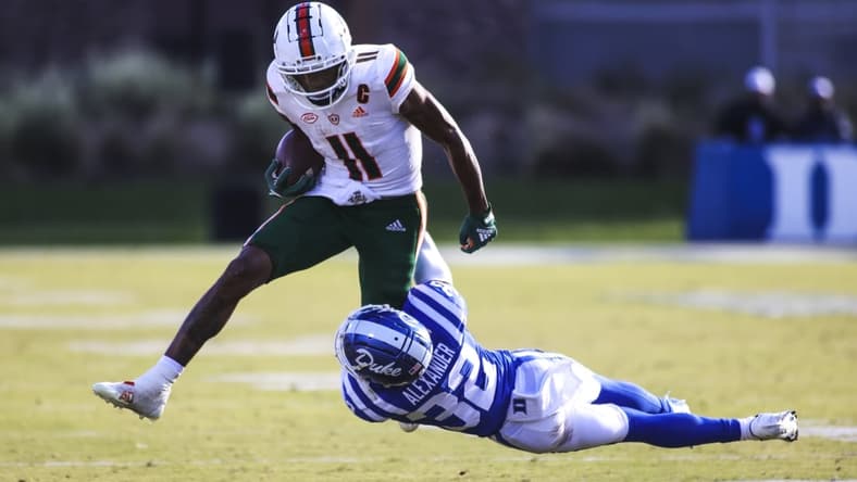 Nov 27, 2021; Durham, North Carolina, USA; Miami Hurricanes wide receiver Charleston Rambo (11) with the ball while Duke Blue Devils safety Jalen Alexander (32) tries to tackle him during the second half of the game against the Miami Hurricanes at Wallace Wade Stadium. at Wallace Wade Stadium. Mandatory Credit: Jaylynn Nash-USA TODAY Sports