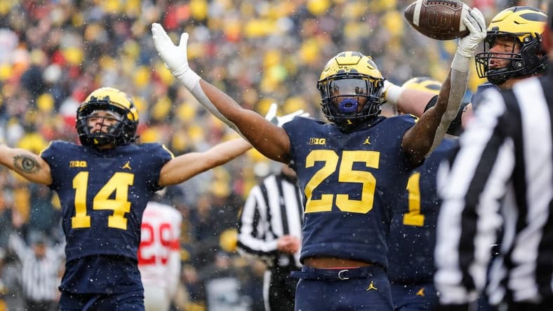 Michigan running back Hassan Haskins (25) celebrates  scoring a touchdown against Ohio State during the second half at Michigan Stadium in Ann Arbor on Saturday, Nov. 27, 2021.

michigan happy