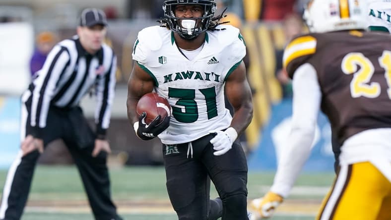 Nov 27, 2021; Laramie, Wyoming, USA; Hawaii Rainbow Warriors running back Dedrick Parson (31) runs against the Wyoming Cowboys during the fourth quarter at Jonah Field at War Memorial Stadium. Mandatory Credit: Troy Babbitt-USA TODAY Sports