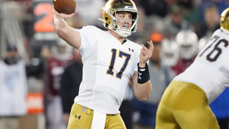 Nov 27, 2021; Stanford, California, USA; Notre Dame Fighting Irish quarterback Jack Coan (17) throws a pass during the third quarter against the Stanford Cardinal at Stanford Stadium. Mandatory Credit: Darren Yamashita-USA TODAY Sports