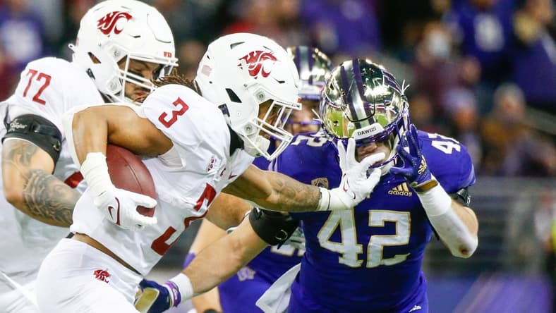 Nov 26, 2021; Seattle, Washington, USA; Washington State Cougars running back Deon McIntosh (3) and Washington Huskies linebacker Carson Bruener (42) during the first quarter at Alaska Airlines Field at Husky Stadium. Mandatory Credit: Joe Nicholson-USA TODAY Sports