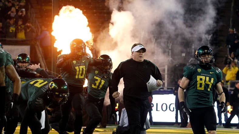 Head Coach Chip Kelly, center, and the team take the field for the first Pac-12 Championship game at Autzen in 2011.

Eug 113021 Pac12 Champs 01