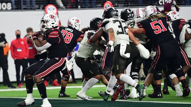 December 3, 2021; Las Vegas, NV, USA; Utah Utes running back Tavion Thomas (9) runs the ball in for a touchdown against the Oregon Ducks during the first half in the 2021 Pac-12 Championship Game at Allegiant Stadium. Mandatory Credit: Gary A. Vasquez-USA TODAY Sports