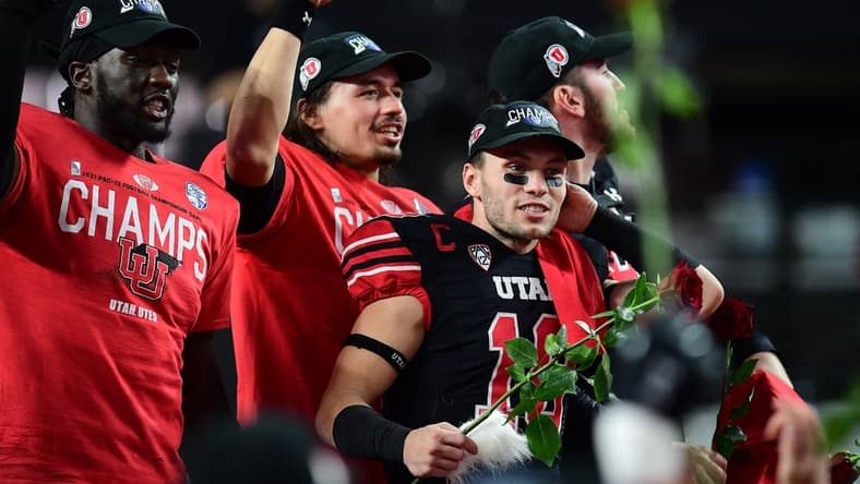 December 3, 2021; Las Vegas, NV, USA; Utah Utes linebacker Devin Lloyd (0) quarterback Cameron Rising (7) and wide receiver Britain Covey (18) celebrate the victory against the Oregon Ducks in the 2021 Pac-12 Championship Game at Allegiant Stadium. Mandatory Credit: Gary A. Vasquez-USA TODAY Sports