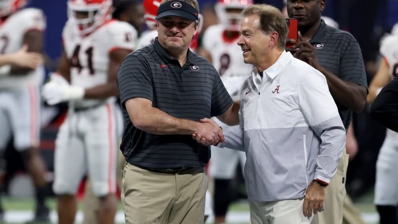 Dec 4, 2021; Atlanta, GA, USA; Georgia Bulldogs head coach Kirby Smart greets Alabama Crimson Tide head coach Nick Saban before the SEC championship game at Mercedes-Benz Stadium.