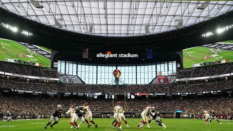Dec 5, 2021; Paradise, Nevada, USA; A general overall view as Washington Football Team quarterback Taylor Heinicke (4) throws the ball against the Washington Football Team  in the first half at Allegiant Stadium. Mandatory Credit: Kirby Lee-USA TODAY Sports