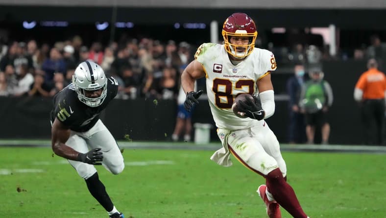 Dec 5, 2021; Paradise, Nevada, USA; Washington Football Team tight end Logan Thomas (82) is defended by Las Vegas Raiders linebacker Divine Deablo (5) on a 35-yard reception in the second half at Allegiant Stadium. Mandatory Credit: Kirby Lee-USA TODAY Sports