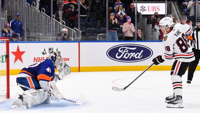 Dec 5, 2021; Elmont, New York, USA; Chicago Blackhawks right wing Patrick Kane (88) scores the wining goal on New York Islanders goaltender Semyon Varlamov (40) during shootouts  at UBS Arena. Mandatory Credit: Dennis Schneidler-USA TODAY Sports