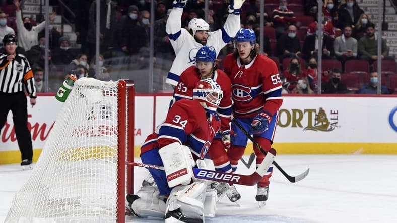Dec 7, 2021; Montreal, Quebec, CAN; Tampa Bay Lightning forward Pat Maroon (14) celebrates next to Montreal Canadiens defenseman Kale Clague (43) and teammate forward Michael Pezzetta (55) after scoring a goal against goalie Jake Allen (34) during the first period at the Bell Centre. Mandatory Credit: Eric Bolte-USA TODAY Sports