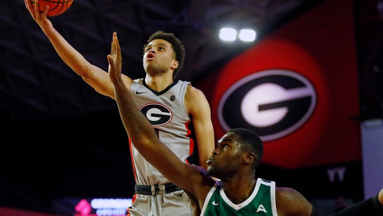 Georgia's Jabri Abdur-Rahim (1) takes a shot over Jacksonville forward Mike Marsh (12) during an NCAA basketball game between Jacksonville and Georgia in Athens, Ga., on Tuesday, Dec. 7, 2021. Georgia won 69-58.