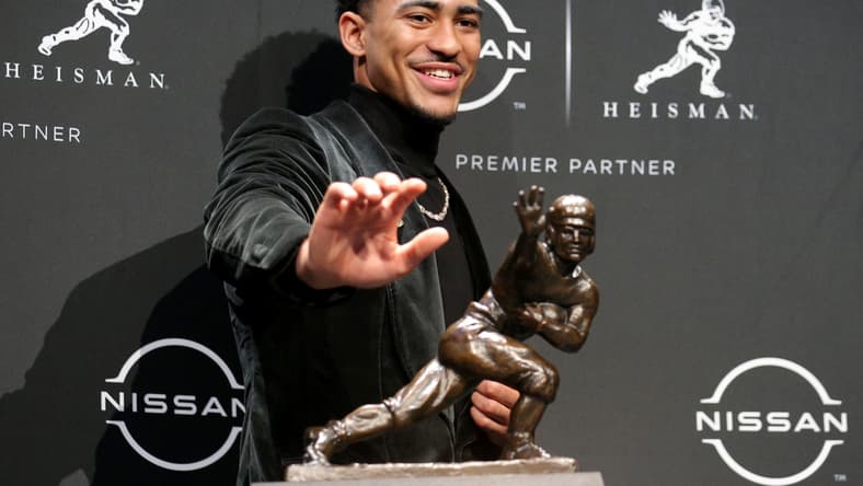 Dec 11, 2021; New York, NY, USA; 2021 Heisman winner Alabama quarterback Bryce Young poses for pictures with the trophy during a press conference at the New York Marriott Marquis in New York City. Mandatory Credit: Brad Penner-USA TODAY Sports