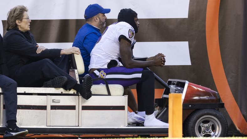 Dec 12, 2021; Cleveland, Ohio, USA; Baltimore Ravens quarterback Lamar Jackson (8) rides the medical cart back to the locker room during the second quarter against the Cleveland Browns at FirstEnergy Stadium. Mandatory Credit: Scott Galvin-USA TODAY Sports