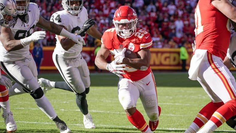 Dec 12, 2021; Kansas City, Missouri, USA; Kansas City Chiefs running back Clyde Edwards-Helaire (25) runs in for a touchdown against the Las Vegas Raiders during the first half at GEHA Field at Arrowhead Stadium. Mandatory Credit: Denny Medley-USA TODAY Sports