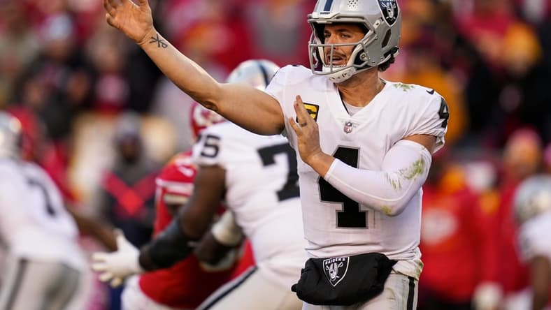 Dec 12, 2021; Kansas City, Missouri, USA; Las Vegas Raiders quarterback Derek Carr (4) throws a pass against the Kansas City Chiefs during the second half at GEHA Field at Arrowhead Stadium. Mandatory Credit: Jay Biggerstaff-USA TODAY Sports