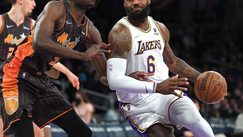 Dec 12, 2021; Los Angeles, California, USA; Orlando Magic center Mo Bamba (5) guards Los Angeles Lakers forward LeBron James (6) as he drives to the basket in the first quarter of the game at Staples Center. Mandatory Credit: Jayne Kamin-Oncea-USA TODAY Sports