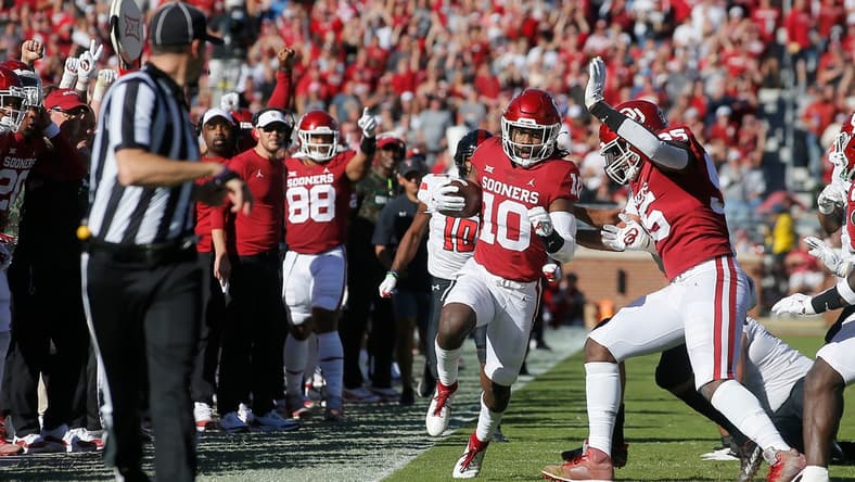 OU safety Pat Fields (10) returns an interception against Texas Tech on Oct. 30 in Norman.

cover
