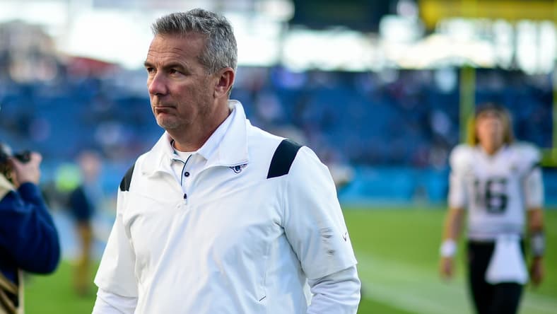 Dec 12, 2021; Nashville, Tennessee, USA;  Jacksonville Jaguars head coach Urban Meyer walks from the field after the game as quarterback Trevor Lawrence (16) follows against the Tennessee Titans at Nissan Stadium. Mandatory Credit: Steve Roberts-USA TODAY Sports