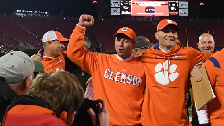 Clemson head coach Dabo Swinney and quarterbacks coach Brandon Streeter celebrate with the team after beating Louisville 30-24 at Cardinal Stadium in Louisville, Kentucky Saturday, November 6, 2021.

Ncaa Football Clemson At Louisville